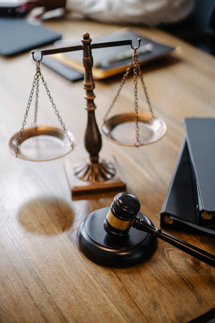 services-02 A striking image featuring a brass justice scale and gavel on a wooden desk, symbolizing law and justice.